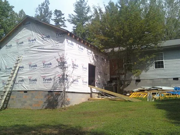 Tyvek wrapped gable on a new room addition beside an existing home in Central
